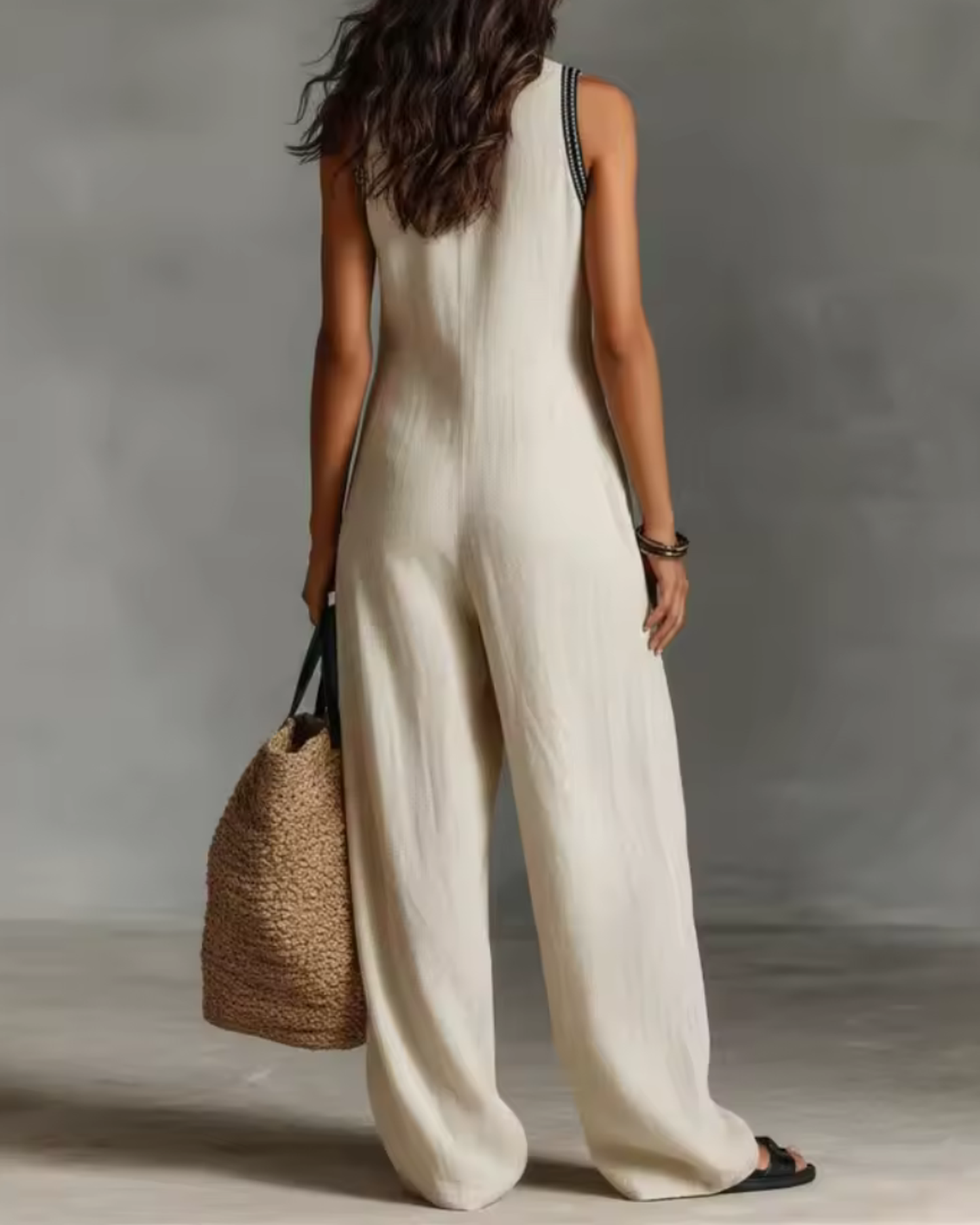 back view of white sleeveless jumpsuit with elegant embroidered details clean modern lines and versatile feminine style ideal for everyday sophistication and city wear