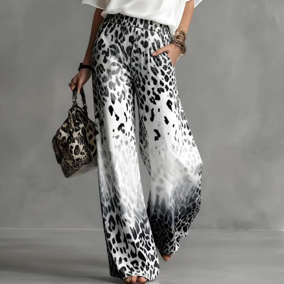close up of gray ombre leopard print pants with fluid silhouette and lightweight movement sophisticated resort wear inspired style for vacations and elevated everyday looks