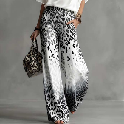 close up of gray ombre leopard print pants with fluid silhouette and lightweight movement sophisticated resort wear inspired style for vacations and elevated everyday looks