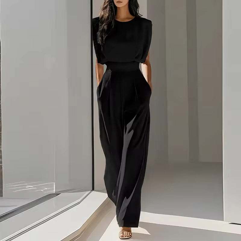 elegant black sleeveless jumpsuit for women with round neckline and tailored waist belt timeless sophisticated style perfect for business events dinners and special occasions