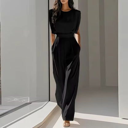 elegant black sleeveless jumpsuit for women with round neckline and tailored waist belt timeless sophisticated style perfect for business events dinners and special occasions