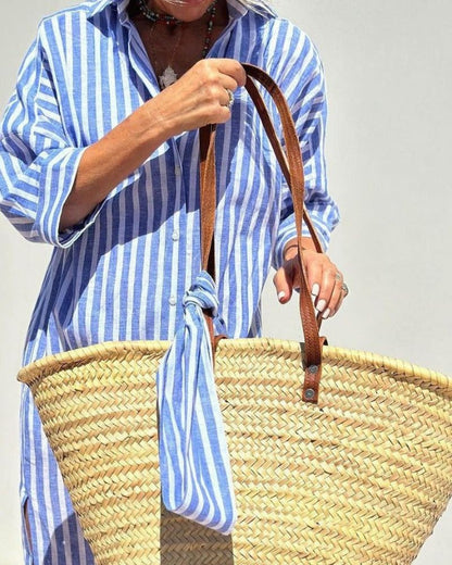 close up of blue striped shirt midi dress featuring shirt collar button front and breathable relaxed design perfect for travel coastal holidays and everyday elegance