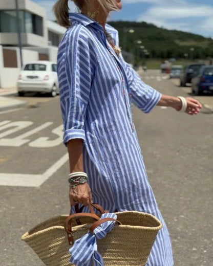side view of blue striped shirt midi dress in motion highlighting the flowing silhouette comfortable fit and timeless resort wear style for holidays and outdoor walks