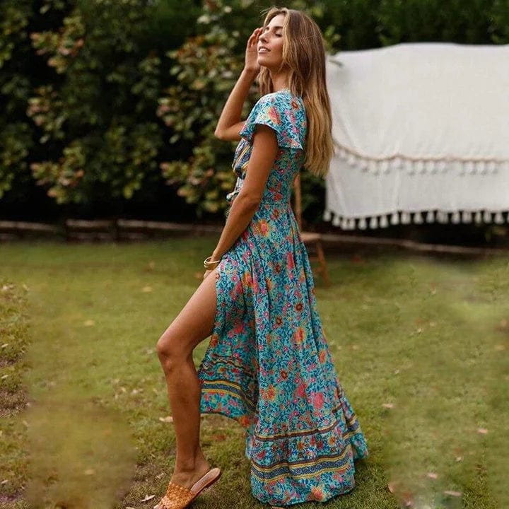 side view of elegant flowy maxi dress highlighting the high slit and graceful silhouette in a garden setting ideal for summer holidays stylish daytime outings and sophisticated occasions