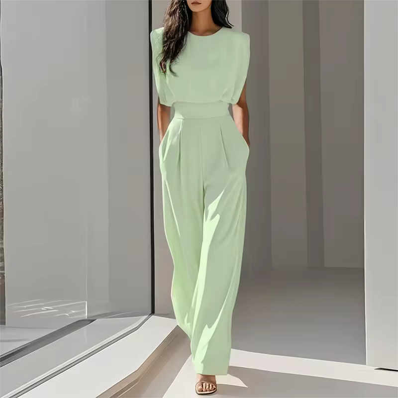 elegant green sleeveless jumpsuit for women with round neckline and waist defining belt polished contemporary style perfect for work dinners and sophisticated day to night outfits