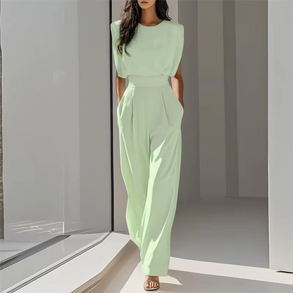 elegant green sleeveless jumpsuit for women with round neckline and waist defining belt polished contemporary style perfect for work dinners and sophisticated day to night outfits