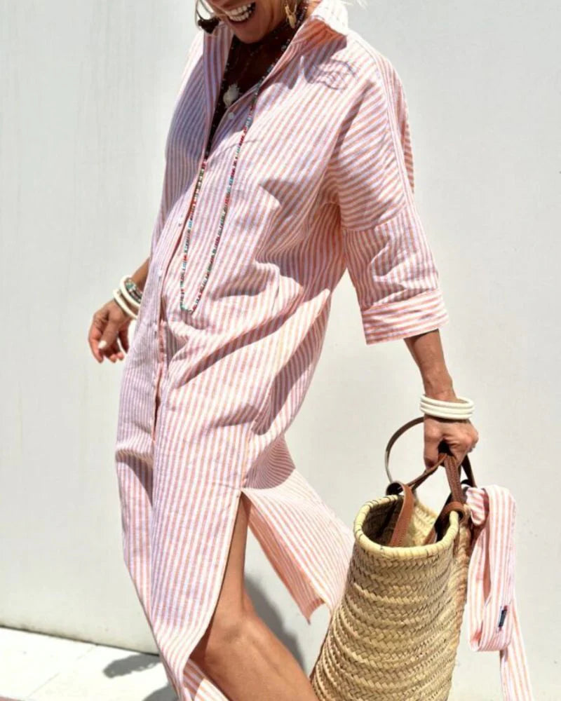 side view of pink vertically striped shirt midi dress with relaxed silhouette and three quarter sleeves perfect for summer vacations beachside strolls and everyday comfort