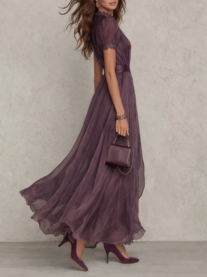 side view of purple maxi dress with high neck lace accents and flattering waist definition elegant occasion wear for weddings celebrations and formal gatherings