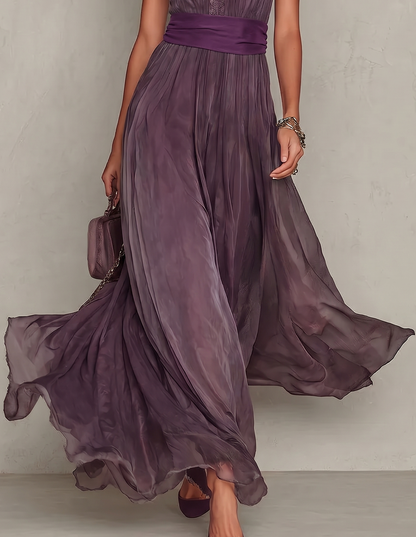 close up of purple maxi dress skirt with elegant drape and flowing silhouette refined feminine fashion ideal for ceremonies and special occasions