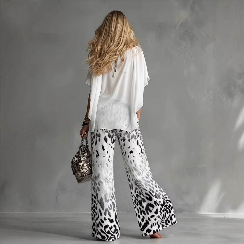 back view of elegant two piece set with white blouse and gray ombre leopard pants refined feminine silhouette perfect for travel and sophisticated casual occasions