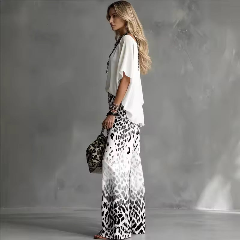 side view of elegant two piece set with flowing leopard print pants and white blouse showcasing relaxed sophistication for vacations and stylish outings