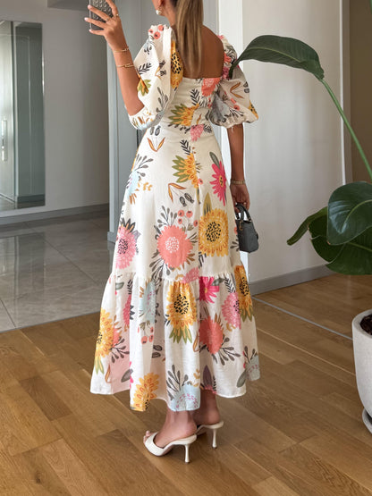 elegant white midi dress with floral print in pink yellow and blue for women square neck and puff sleeves refined feminine fashion perfect for occasions
