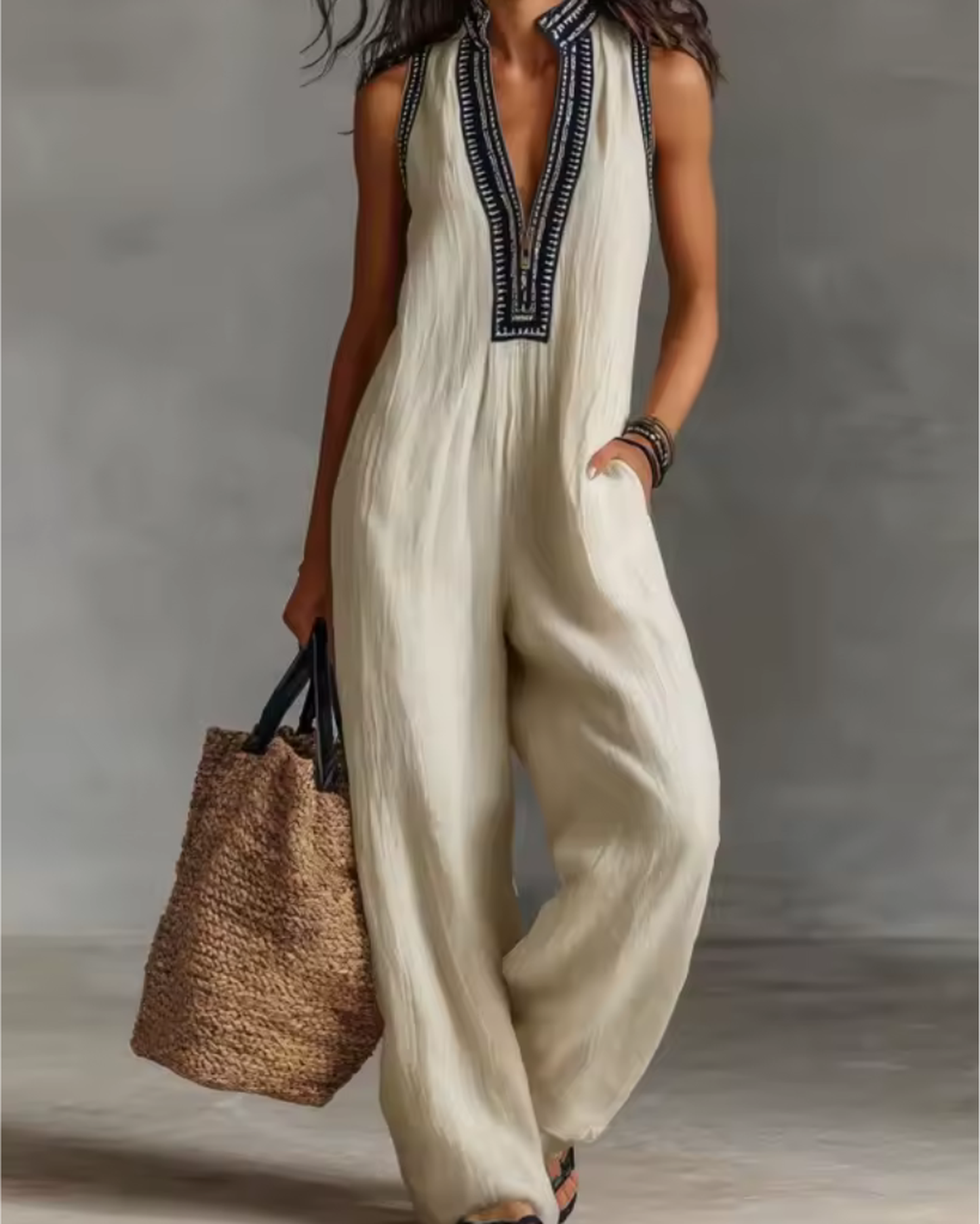 elegant white sleeveless jumpsuit for women with high neck zipper and embroidered details modern refined silhouette ideal for travel city outings smart casual looks and everyday elegance